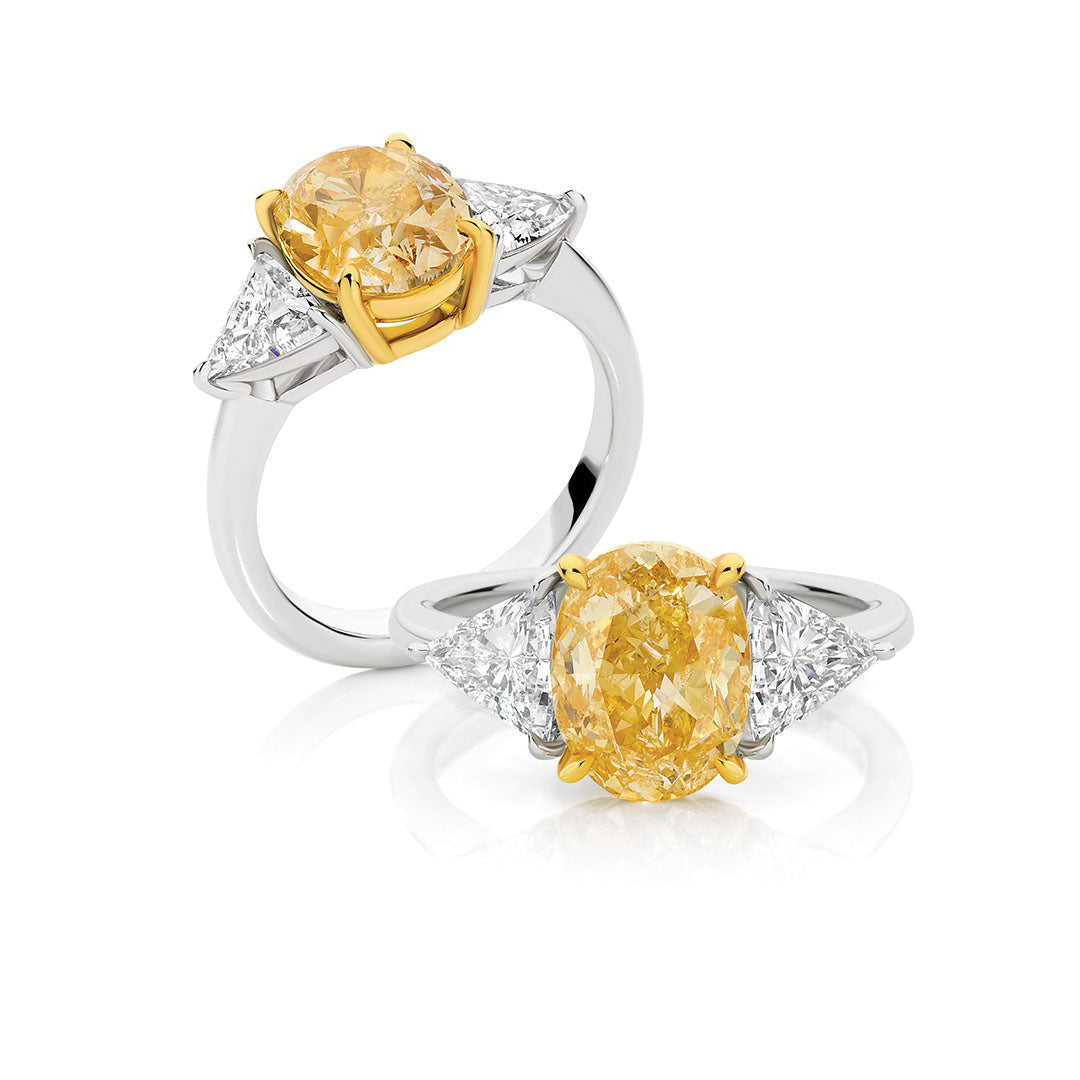 Oval Cut Yellow Diamond and Trilliant Cut Diamond Engagement Ring